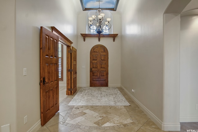entryway with a towering ceiling and an inviting chandelier