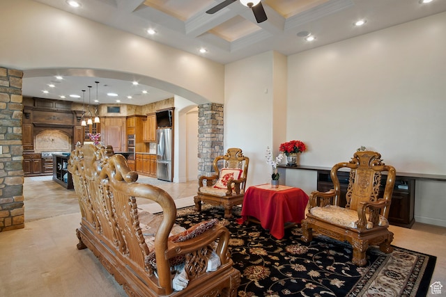 sitting room featuring ceiling fan, beamed ceiling, and coffered ceiling