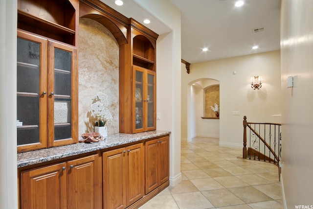 hall with light tile patterned floors