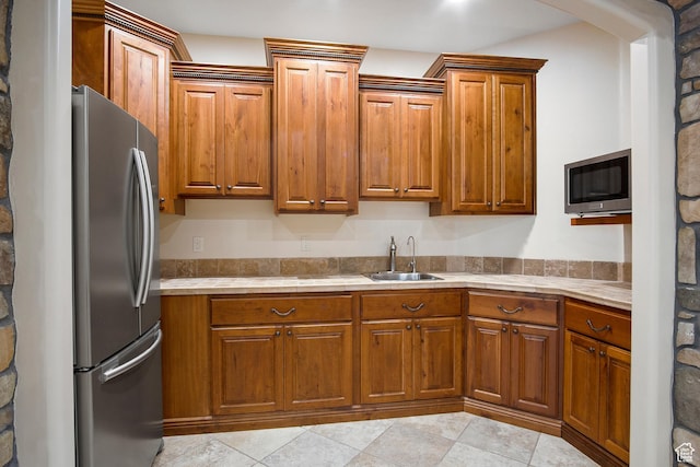 kitchen featuring sink and stainless steel fridge