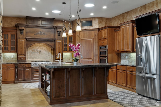 kitchen featuring a center island with sink, pendant lighting, stainless steel appliances, and backsplash