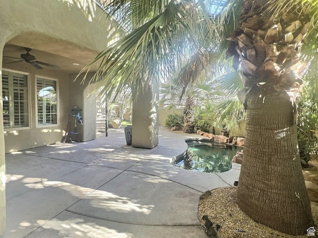 view of swimming pool with a patio and ceiling fan