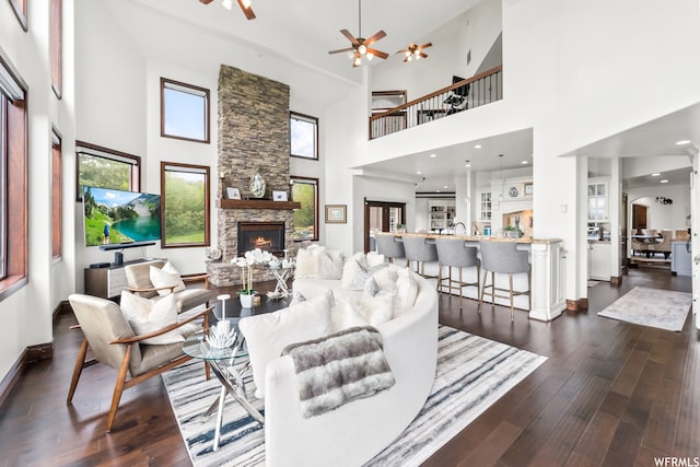 4159 Moose Hollow Rd, Park City, UT 84098 - living room featuring a fireplace, ceiling fan, a high ceiling, and dark hardwood / wood-style flooring
