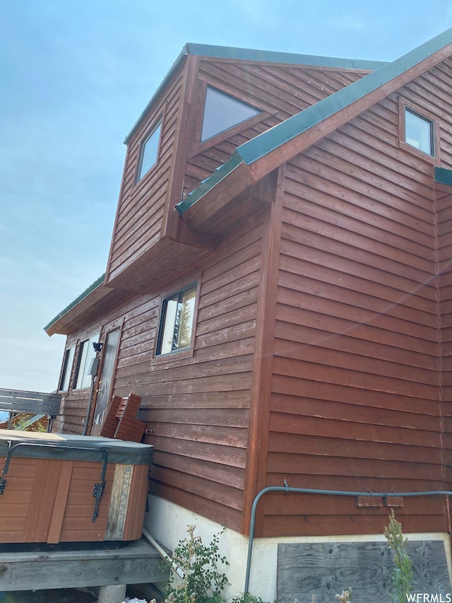 view of property exterior featuring a hot tub