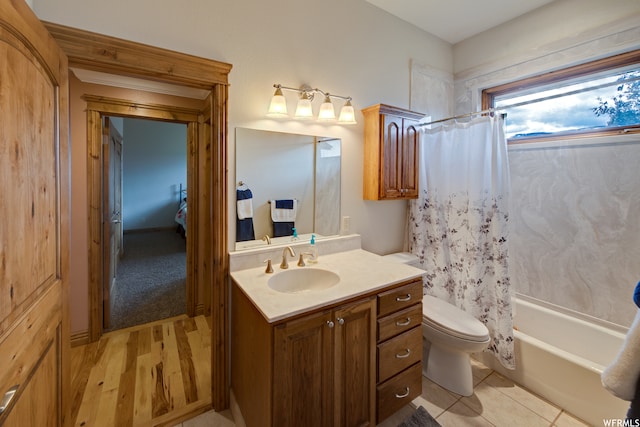 full bathroom with tile flooring, shower / bath combination with curtain, toilet, and vanity