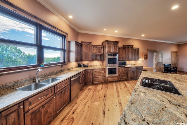 kitchen with sink, stainless steel appliances, light wood-type flooring, and ornamental molding