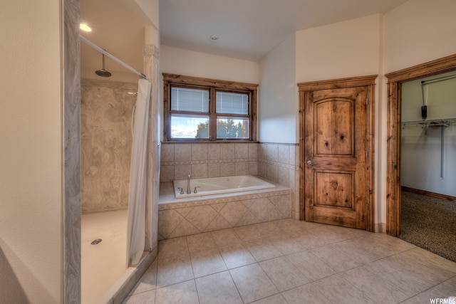 bathroom with tile floors and independent shower and bath
