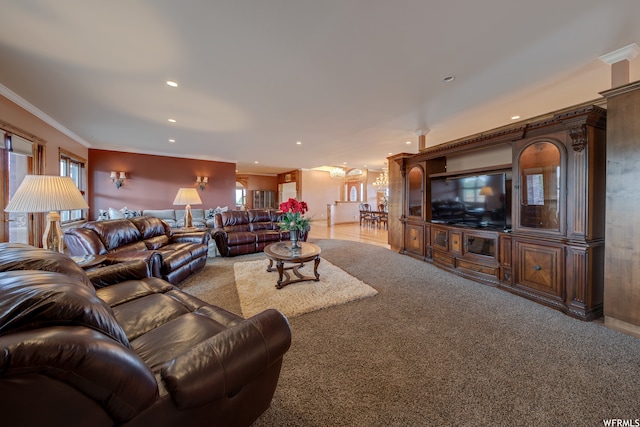 carpeted living room with a healthy amount of sunlight and ornamental molding