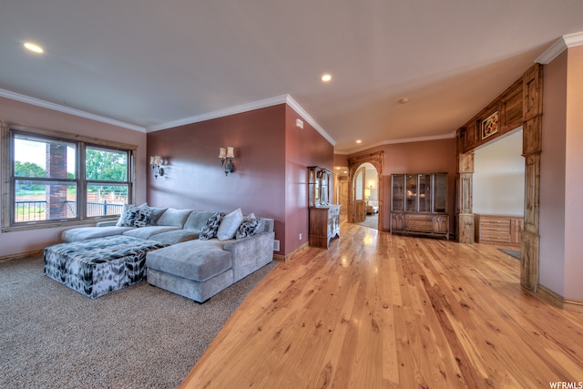 living room with ornamental molding and light wood-type flooring