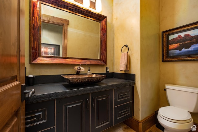 half bath featuring toilet and vanity