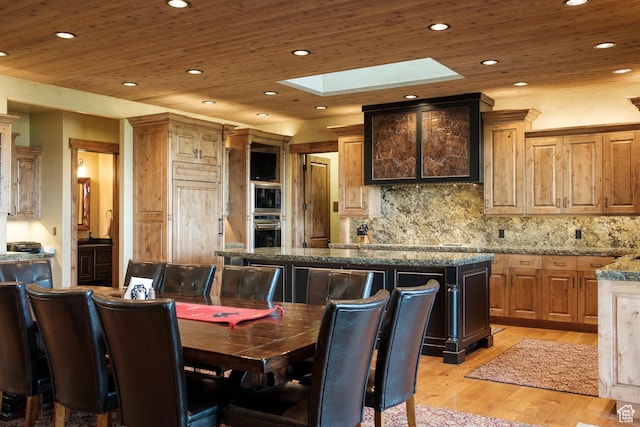 dining area with recessed lighting, wooden ceiling, light wood-style flooring, and a skylight