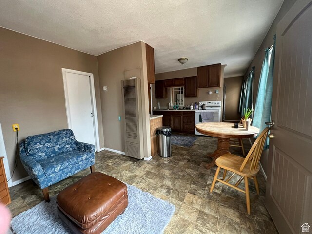 195 E 200 N, Moab, UT 84532 - kitchen with white electric range, a heating unit, light countertops, and stone finish flooring