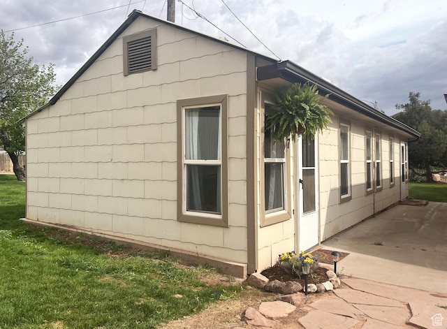 195 E 200 N, Moab, UT 84532 - view of home's exterior featuring a patio area and a lawn