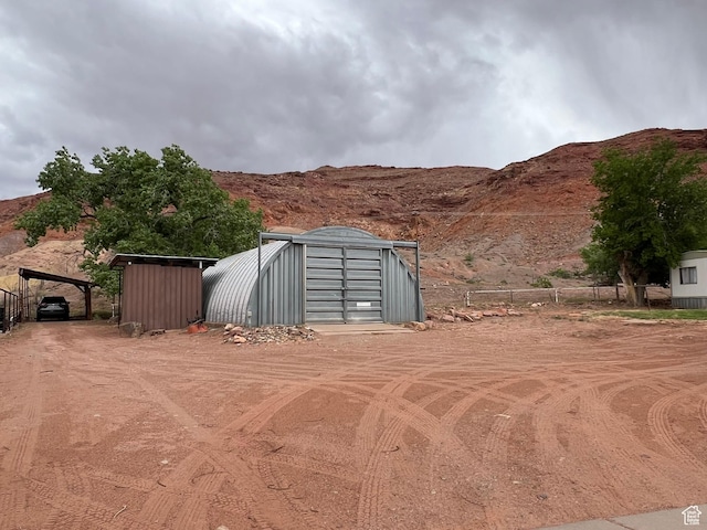 195 E 200 N, Moab, UT 84532 - view of yard featuring a mountain view, a detached carport, and a storage unit