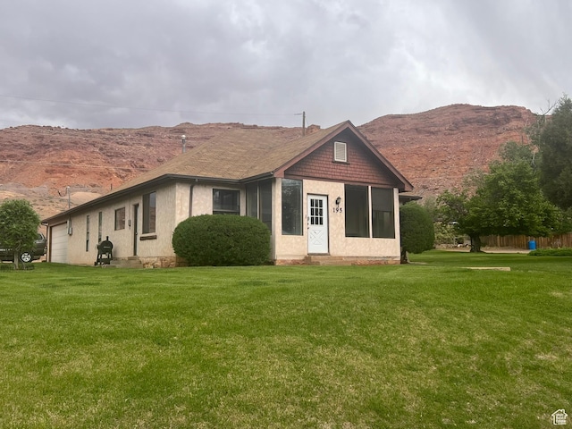 195 E 200 N, Moab, UT 84532 - view of front facade with a garage, a mountain view, a front yard, and entry steps