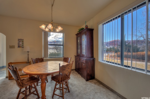 195 E 200 N, Moab, UT 84532 - dining space with light colored carpet, a chandelier, and arched walkways