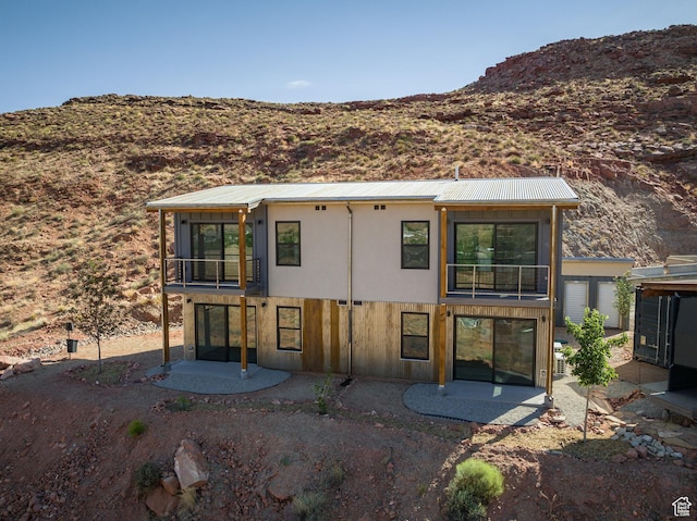 1185 S Murphy Ln Unit 402B, Moab, UT 84532 - back of property featuring a balcony, a patio area, a mountain view, and metal roof