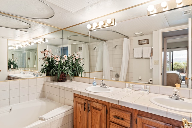 1845 W Canyon Dr Unit 304, St George, UT 84770 - bathroom featuring dual sinks, oversized vanity, and a relaxing tiled bath