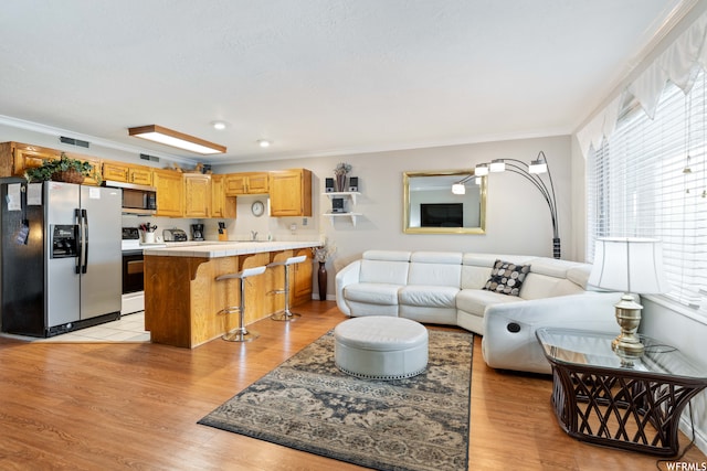 1845 W Canyon Dr Unit 304, St George, UT 84770 - living room with crown molding and light hardwood / wood-style flooring