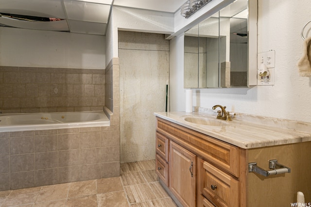 bathroom with a relaxing tiled bath, vanity, and tile flooring