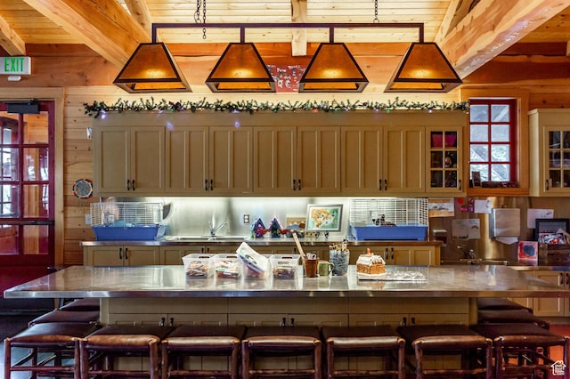 8139 N Sunrise Loop, Park City, UT 84098 - kitchen with beam ceiling, a kitchen breakfast bar, a large island with sink, and wood walls