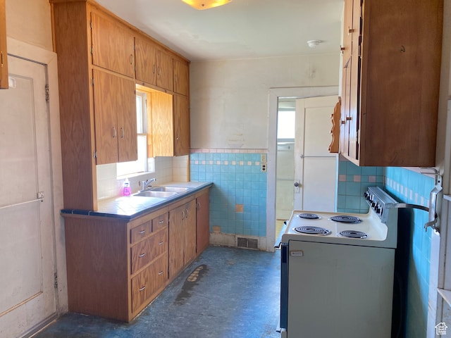 871 N 700 E, Logan, UT 84321 - kitchen with backsplash, plenty of natural light, sink, and white electric range oven