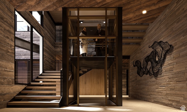 7932 Red Tail Ct, Park City, UT 84060 - staircase featuring wooden ceiling, tile patterned flooring, a high ceiling, and wooden walls
