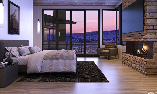 7932 Red Tail Ct, Park City, UT 84060 - bedroom featuring hardwood / wood-style flooring and a stone fireplace