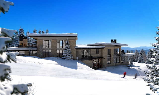 snow covered house with a mountain view