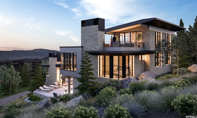 7932 Red Tail Ct, Park City, UT 84060 - back house at dusk featuring a balcony and a patio