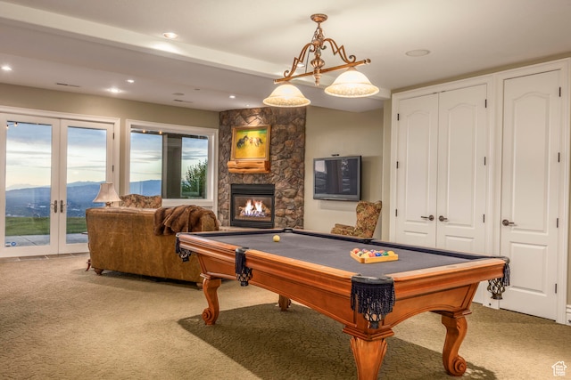 recreation room featuring french doors, pool table, carpet floors, a mountain view, and a fireplace
