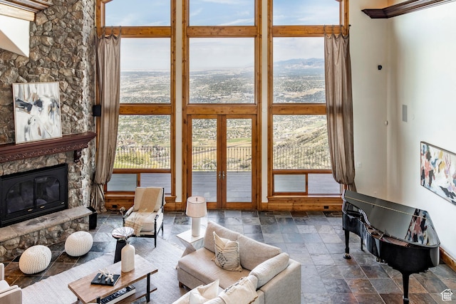 living room with french doors and a stone fireplace