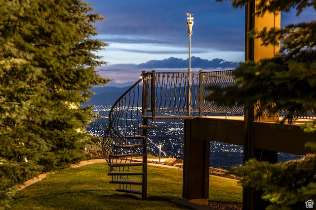 surrounding community with a yard and a mountain view