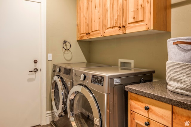 washroom with cabinets and washer and clothes dryer