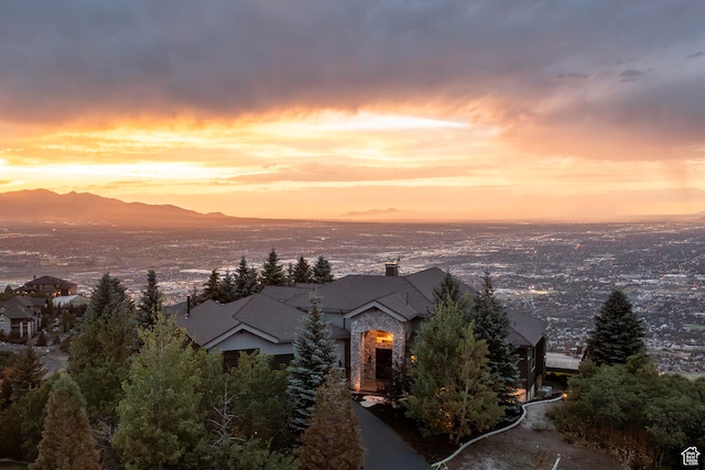 aerial view at dusk featuring a mountain view