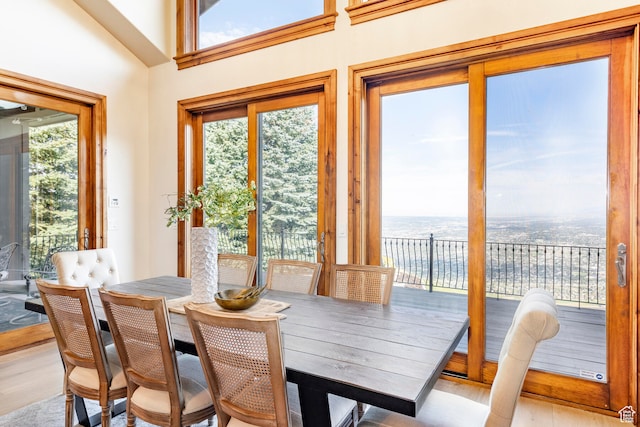 sunroom / solarium featuring a water view, a healthy amount of sunlight, and vaulted ceiling