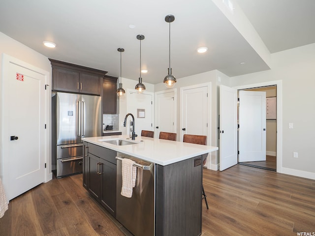 909 W Peace Tree Trl Unit 601, Heber City, UT 84032 - kitchen featuring dark wood-style floors, appliances with stainless steel finishes, hanging light fixtures, light countertops, and a sink