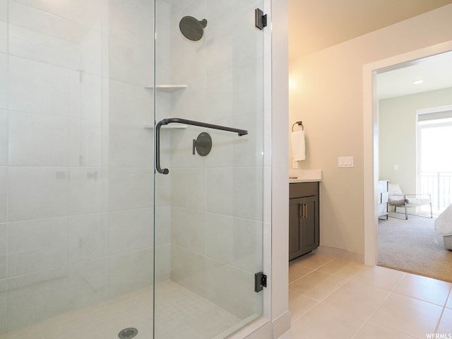 909 W Peace Tree Trl Unit 601, Heber City, UT 84032 - ensuite bathroom featuring connected bathroom, vanity, baseboards, tile patterned floors, and a stall shower