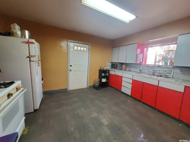 847 Monroe St, Montpelier, ID 83254 - kitchen with white range with gas stovetop, tasteful backsplash, dark wood-type flooring, white cabinets, and sink