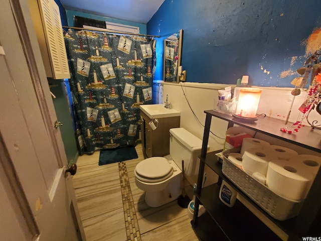847 Monroe St, Montpelier, ID 83254 - bathroom featuring toilet, vanity, and hardwood / wood-style flooring