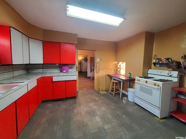 847 Monroe St, Montpelier, ID 83254 - kitchen featuring white gas range oven and dark wood-type flooring