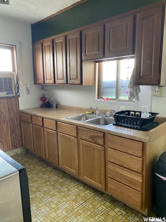 333 W Railroad Ave, Price, UT 84501 - kitchen featuring light tile flooring, a textured ceiling, a healthy amount of sunlight, and sink