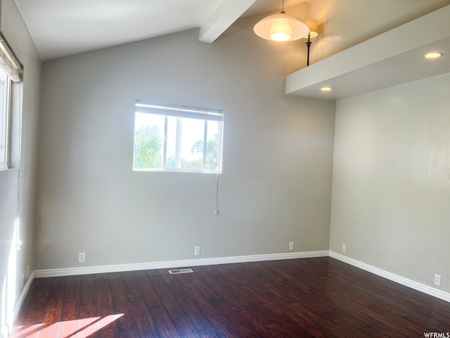 spare room with vaulted ceiling with beams and dark hardwood / wood-style floors