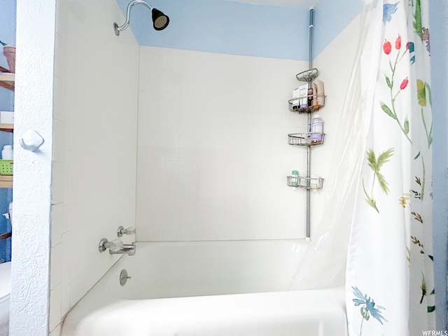 bathroom featuring shower / tub combo with curtain