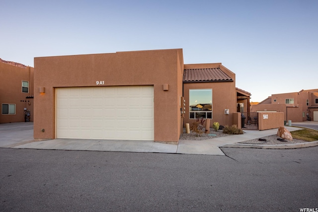 3862 Desert Willow Cir Unit 9-A1, Moab, UT 84532 - adobe home featuring a garage