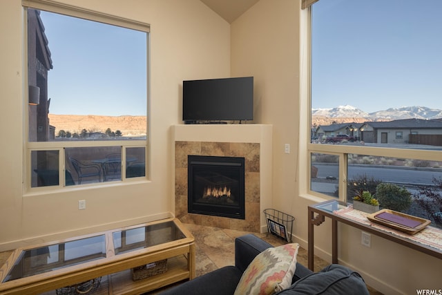 3862 Desert Willow Cir Unit 9-A1, Moab, UT 84532 - living room featuring a tiled fireplace and vaulted ceiling