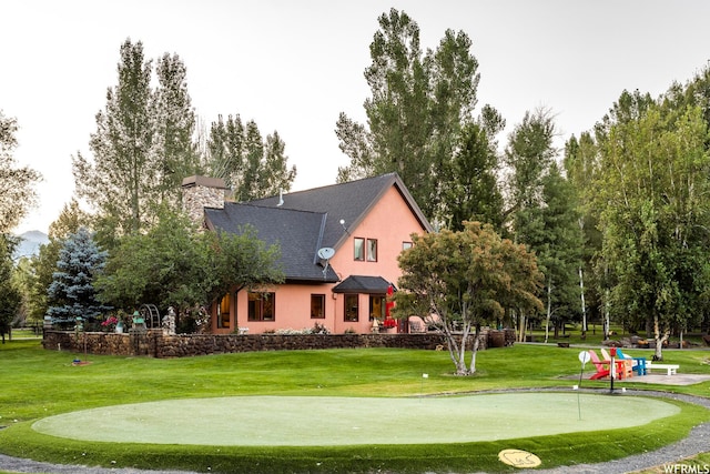 2085 W Midway Ln, Heber City, UT 84032 - back of property with a chimney, stucco siding, and a yard
