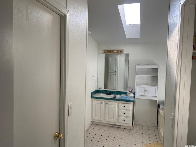 33258 W 8375 S, Fruitland, UT 84027 - bathroom with tile patterned floors, vanity, visible vents, and a skylight