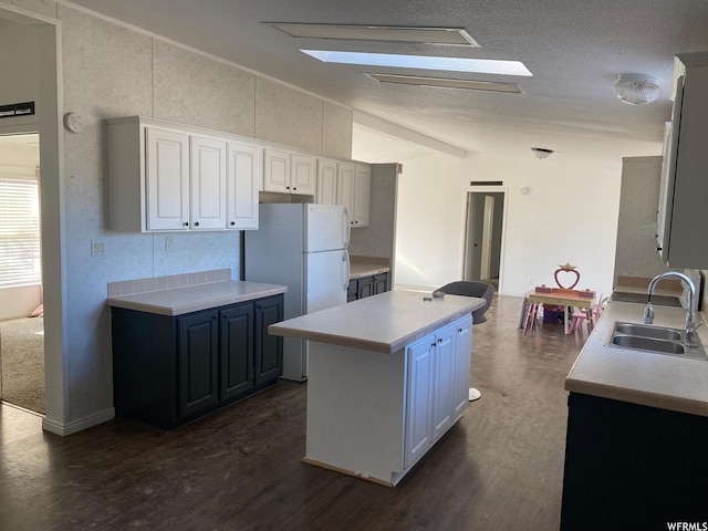 33258 W 8375 S, Fruitland, UT 84027 - kitchen featuring dark wood-type flooring, vaulted ceiling, a center island, light countertops, and a sink