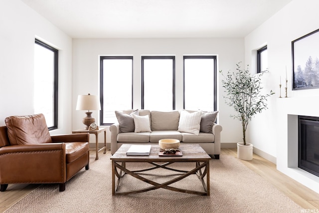 6962 Elk Wallow Dr Unit 7, Park City, UT 84098 - living area featuring baseboards, light wood-style floors, and a glass covered fireplace